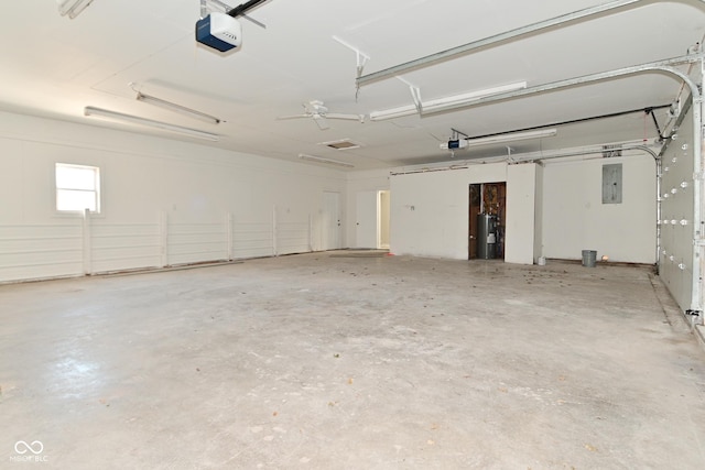 garage with electric panel, a garage door opener, and water heater