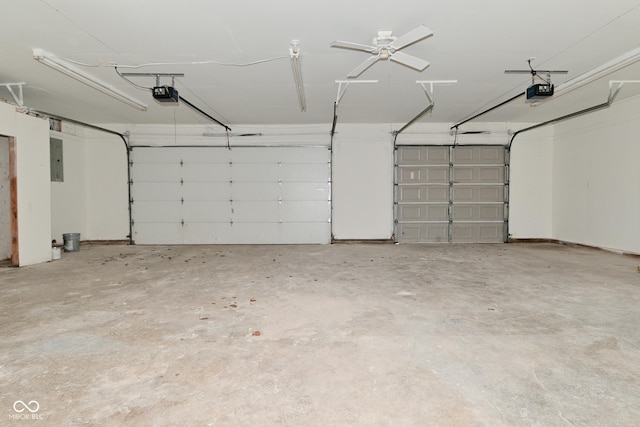 garage with electric panel and a garage door opener