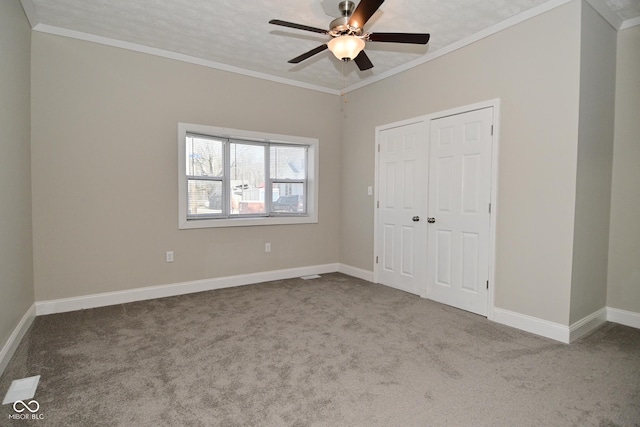 unfurnished bedroom with baseboards, carpet floors, and crown molding