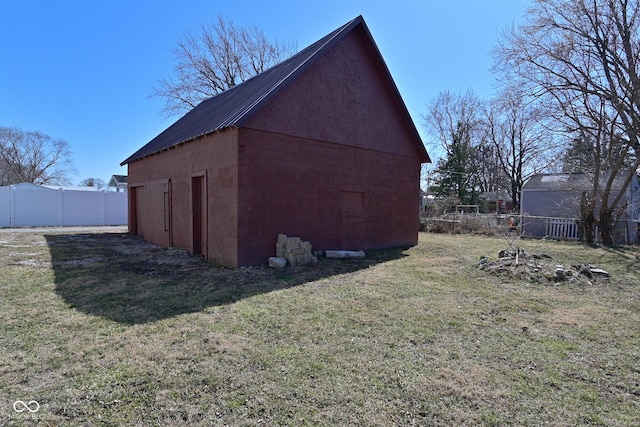 view of outdoor structure featuring an outbuilding and fence