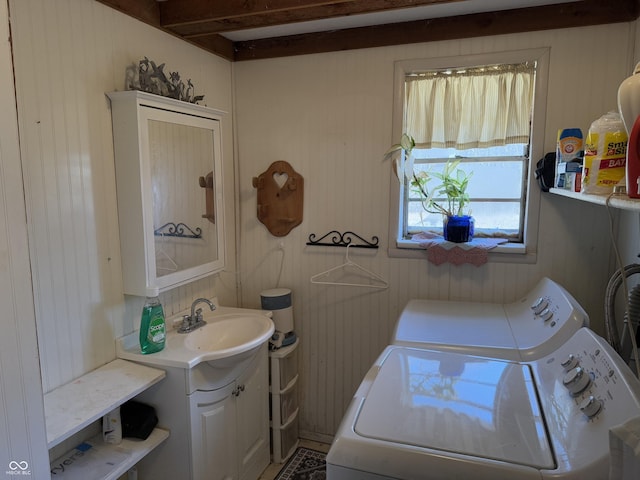 washroom with washer and dryer, laundry area, and a sink