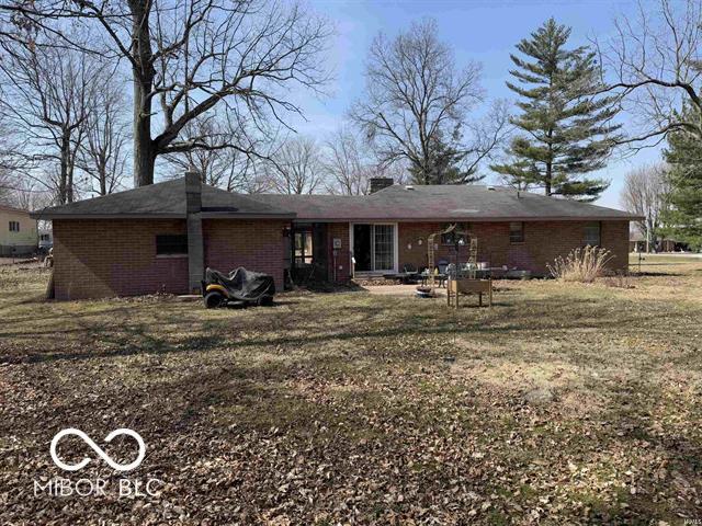 back of house with brick siding