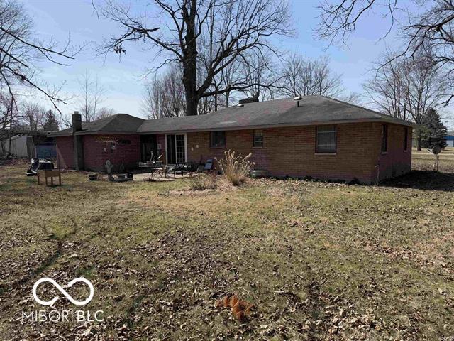 rear view of house featuring brick siding