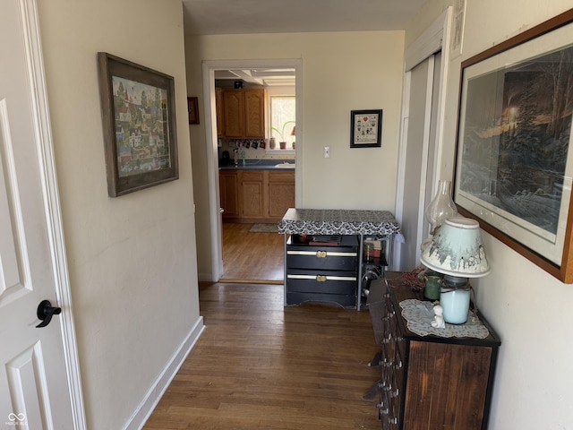 hall with dark wood finished floors and baseboards