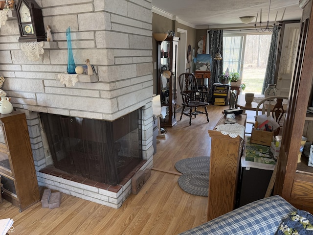 interior space with wood finished floors, crown molding, and a fireplace