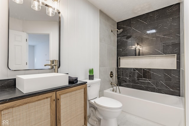 full bath with vanity, a textured ceiling, shower / bathing tub combination, toilet, and tile patterned floors