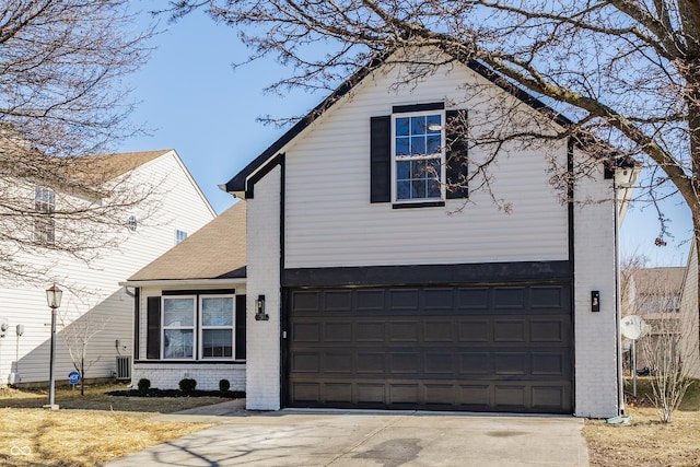 traditional-style house with concrete driveway, a garage, cooling unit, and brick siding