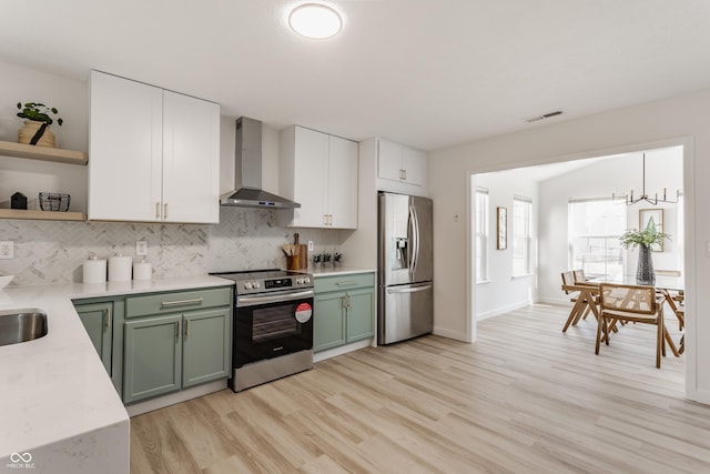 kitchen with visible vents, open shelves, stainless steel appliances, wall chimney range hood, and green cabinetry