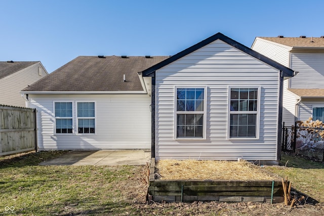 back of property with a patio, a lawn, and a fenced backyard