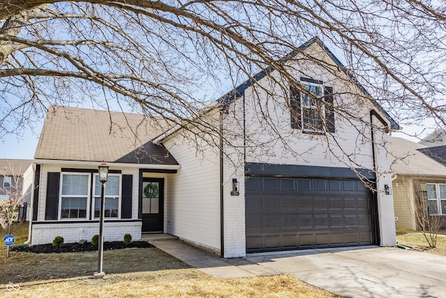 view of front facade with brick siding, driveway, and roof with shingles