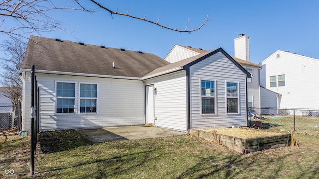 rear view of property featuring a patio, fence, a yard, a shingled roof, and a chimney