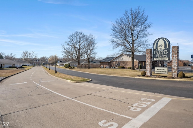 view of street with curbs and a residential view