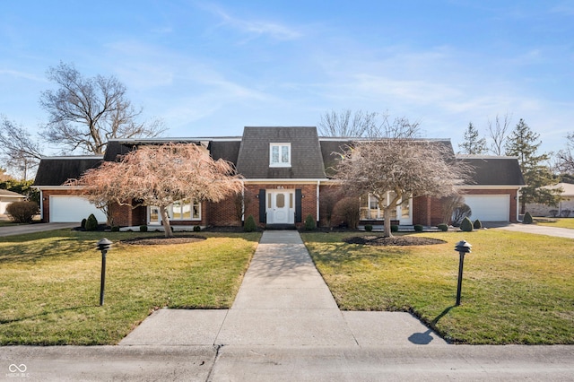 view of front of home featuring brick siding, a front yard, mansard roof, a garage, and driveway