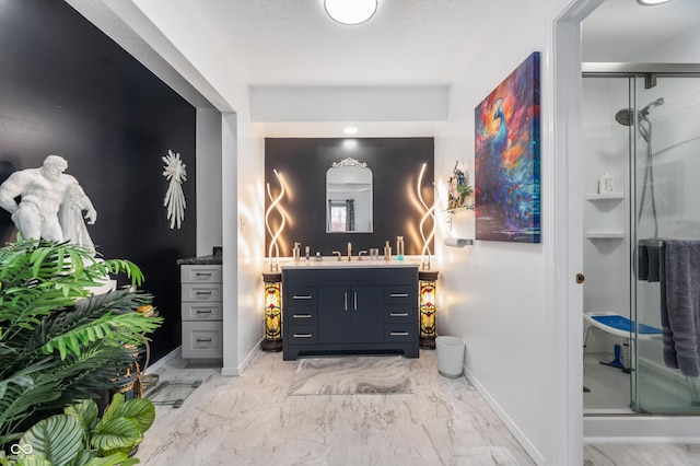 interior space with baseboards, vanity, marble finish floor, and a shower stall