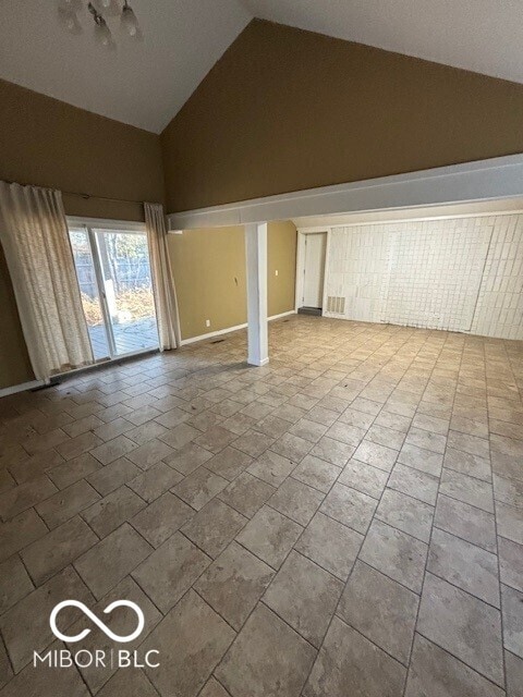 3302 E 42nd St, Indianapolis, IN 46205 - unfurnished living room with visible vents and high vaulted ceiling