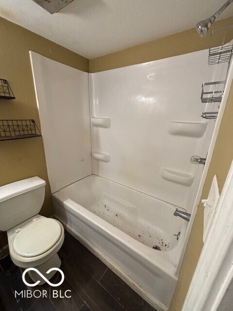 3302 E 42nd St, Indianapolis, IN 46205 - bathroom featuring shower / bathing tub combination, toilet, wood finished floors, and a textured ceiling