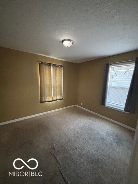 3302 E 42nd St, Indianapolis, IN 46205 - spare room with carpet flooring, baseboards, and a textured ceiling