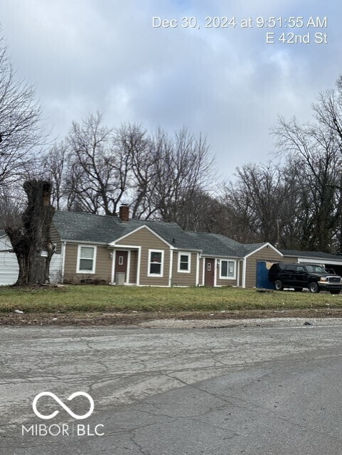 3302 E 42nd St, Indianapolis, IN 46205 - view of front facade featuring a chimney and a front yard