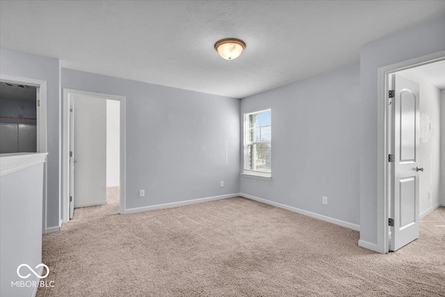 unfurnished bedroom with carpet flooring and baseboards