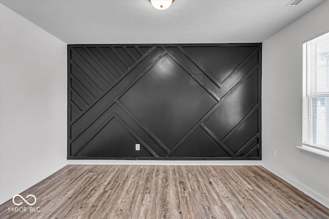 interior space featuring wood finished floors and baseboards