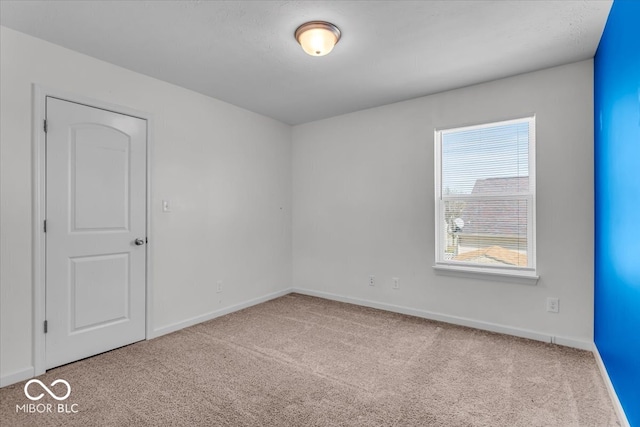 unfurnished room featuring baseboards and carpet floors