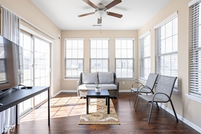 living area with a wealth of natural light, visible vents, and wood finished floors