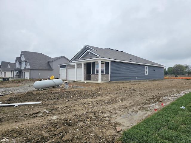 exterior space featuring a garage and brick siding