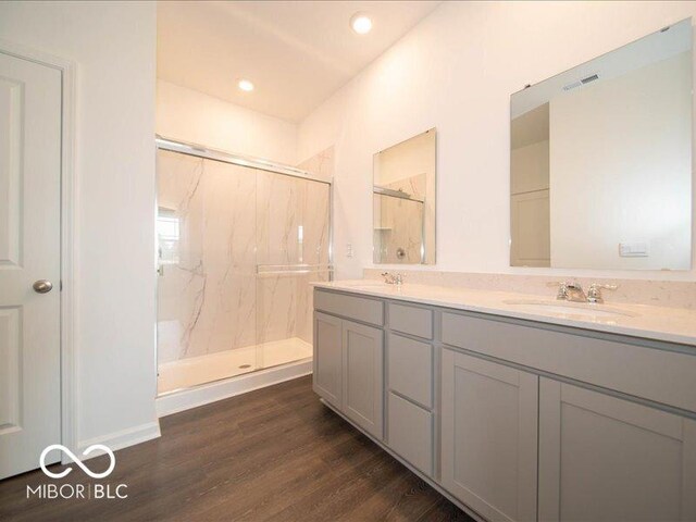 2254 Oakmont Dr, Plainfield, IN 46168 - full bath with double vanity, a marble finish shower, wood finished floors, and recessed lighting