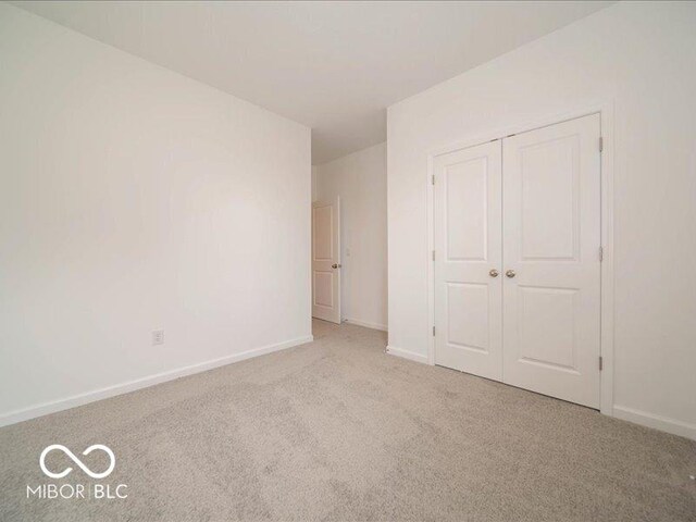 2254 Oakmont Dr, Plainfield, IN 46168 - unfurnished bedroom with carpet flooring, a closet, and baseboards