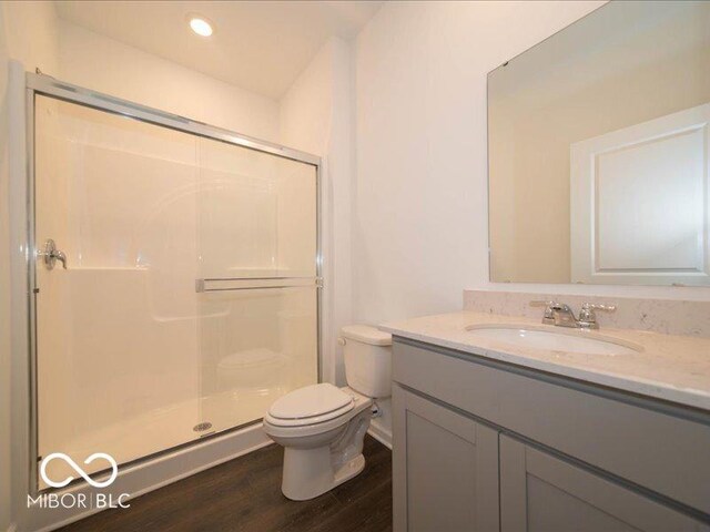 2254 Oakmont Dr, Plainfield, IN 46168 - bathroom featuring toilet, a stall shower, vanity, wood finished floors, and recessed lighting