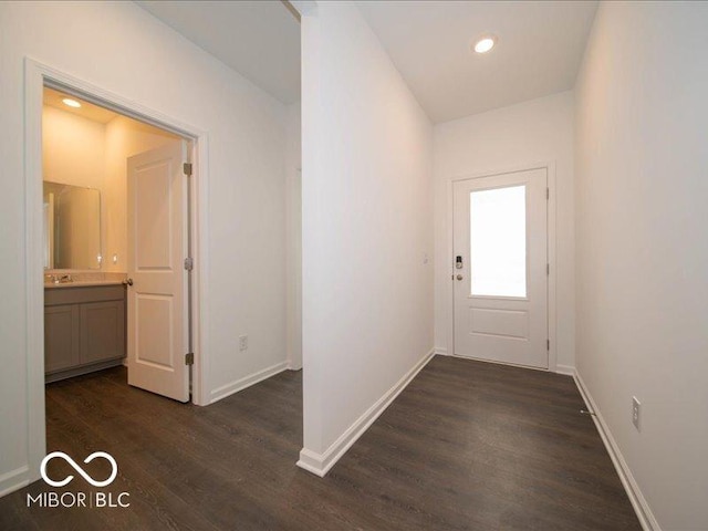 2254 Oakmont Dr, Plainfield, IN 46168 - doorway to outside featuring dark wood-style floors, baseboards, recessed lighting, and a sink