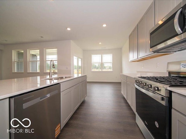 2254 Oakmont Dr, Plainfield, IN 46168 - kitchen featuring stainless steel appliances, a sink, light countertops, dark wood finished floors, and recessed lighting