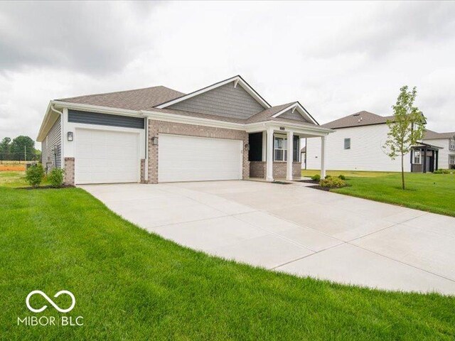 2254 Oakmont Dr, Plainfield, IN 46168 - craftsman-style house featuring an attached garage, brick siding, a front yard, concrete driveway, and covered porch