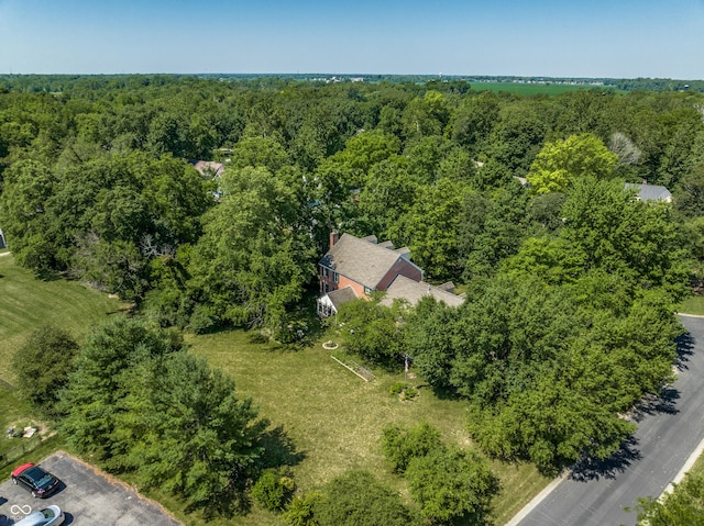 birds eye view of property with a view of trees