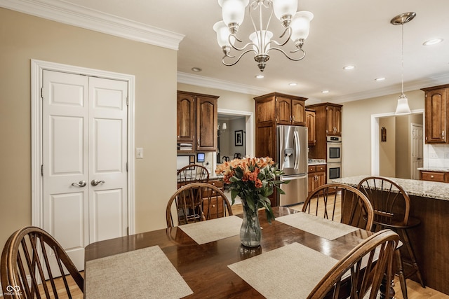 dining space with an inviting chandelier, recessed lighting, and crown molding