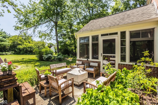 view of patio featuring an outdoor living space and a sunroom