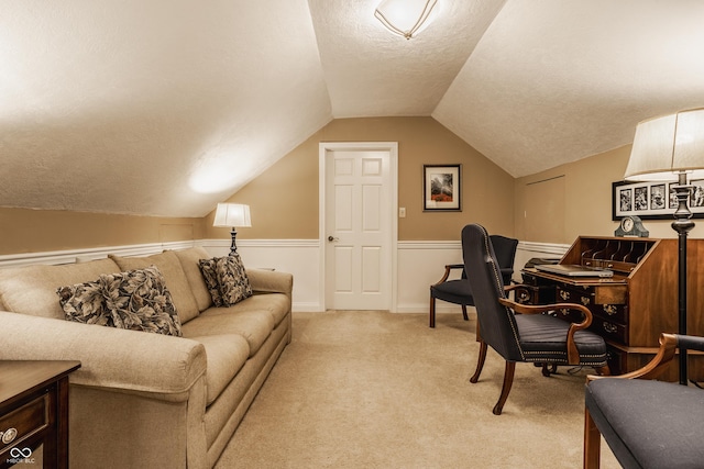 home office with baseboards, light carpet, a textured ceiling, and lofted ceiling