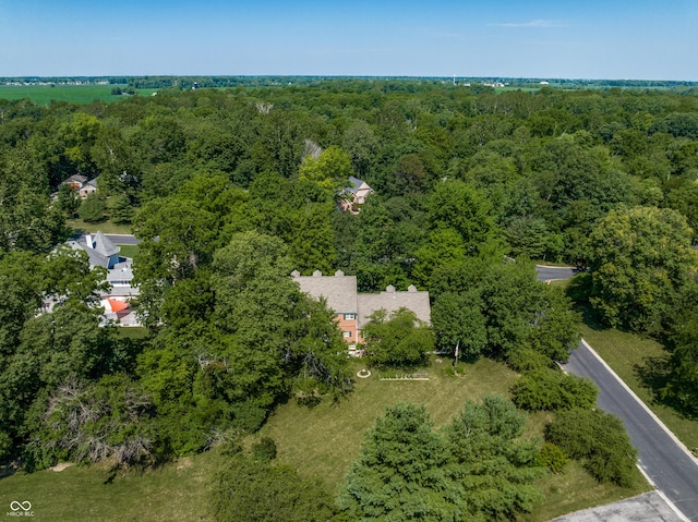 birds eye view of property featuring a view of trees