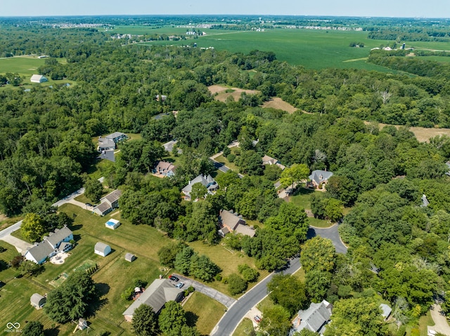 birds eye view of property with a wooded view