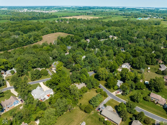 drone / aerial view with a wooded view