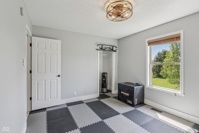unfurnished bedroom with baseboards, visible vents, carpet, and a closet