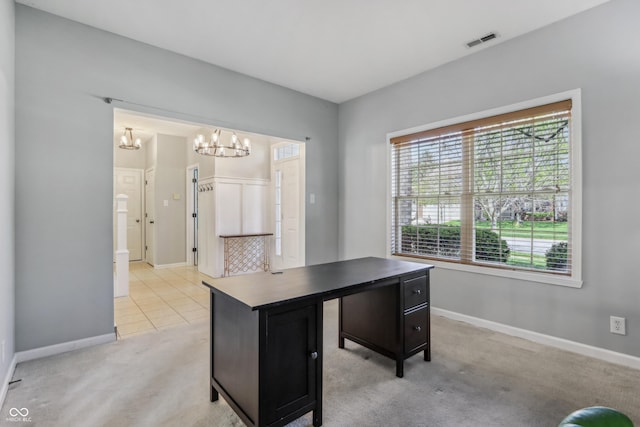 unfurnished office with visible vents, baseboards, light colored carpet, and an inviting chandelier