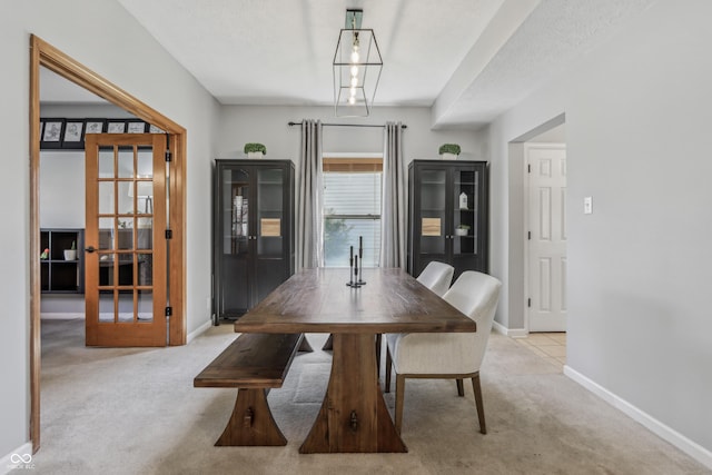 dining area with carpet floors and baseboards