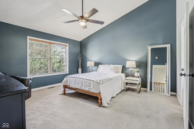 carpeted bedroom featuring baseboards, a ceiling fan, and high vaulted ceiling
