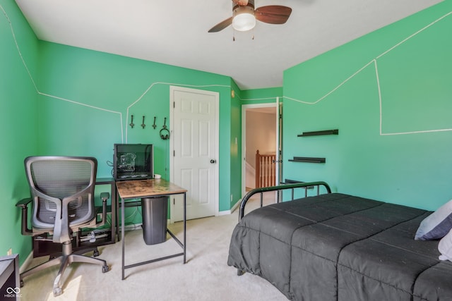 carpeted bedroom with a ceiling fan and baseboards