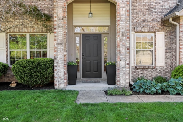 doorway to property with brick siding
