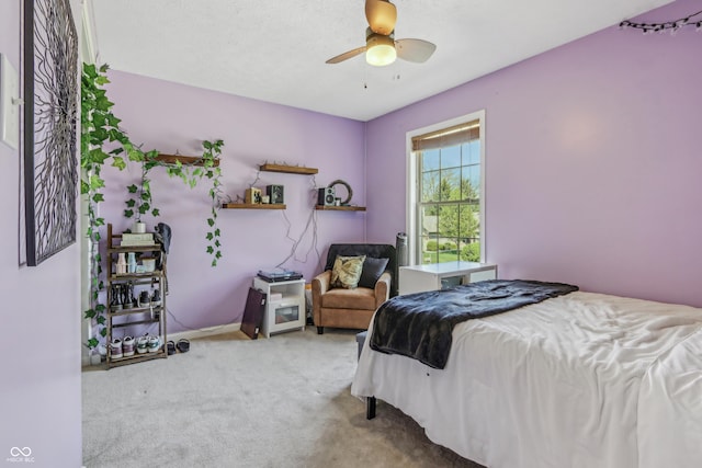 bedroom with carpet floors, ceiling fan, and baseboards