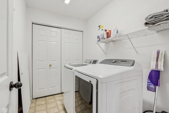 laundry area featuring separate washer and dryer, laundry area, and light floors
