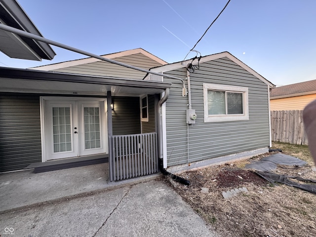 view of front of property with french doors and fence