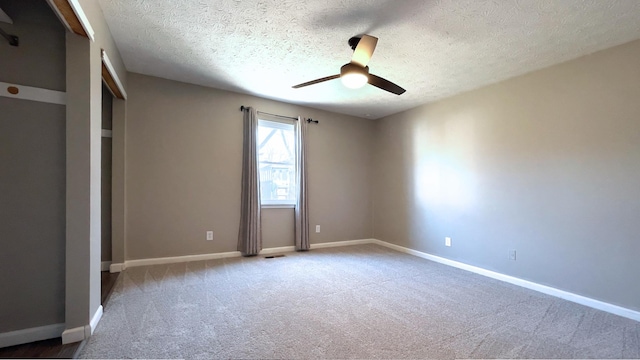 unfurnished bedroom featuring baseboards, carpet floors, and a textured ceiling